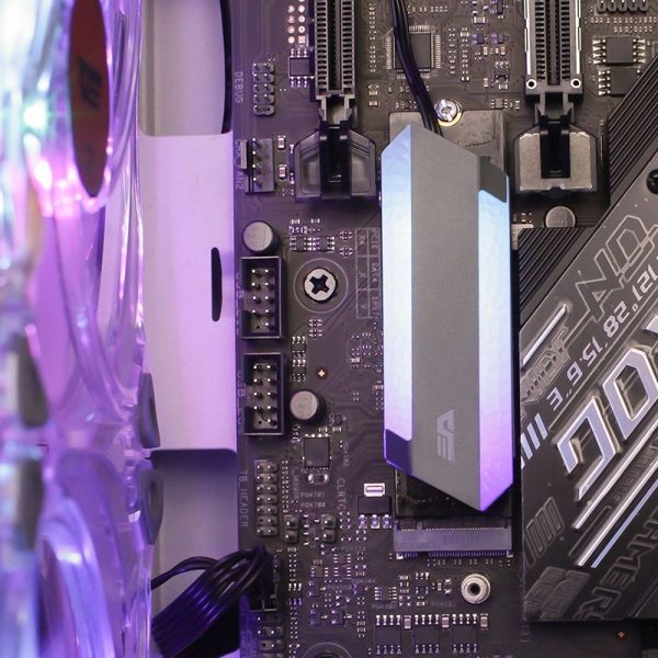 A close-up of a computer motherboard featuring a gray heatsink and colorful lighting accents.
